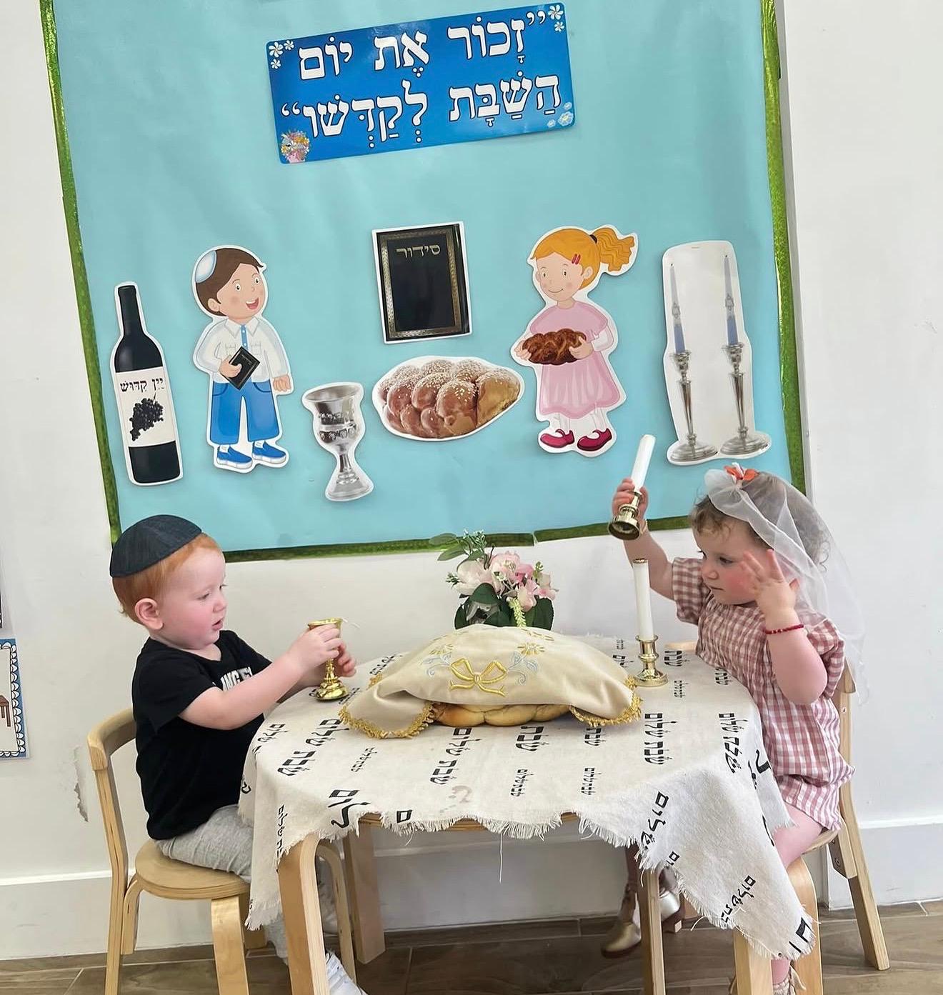 Two toddlers at the Shabbat table